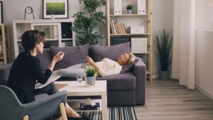 A therapist and patient in a modern office during a counseling session.
