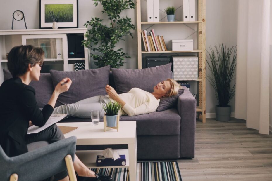 A therapist and patient in a modern office during a counseling session.