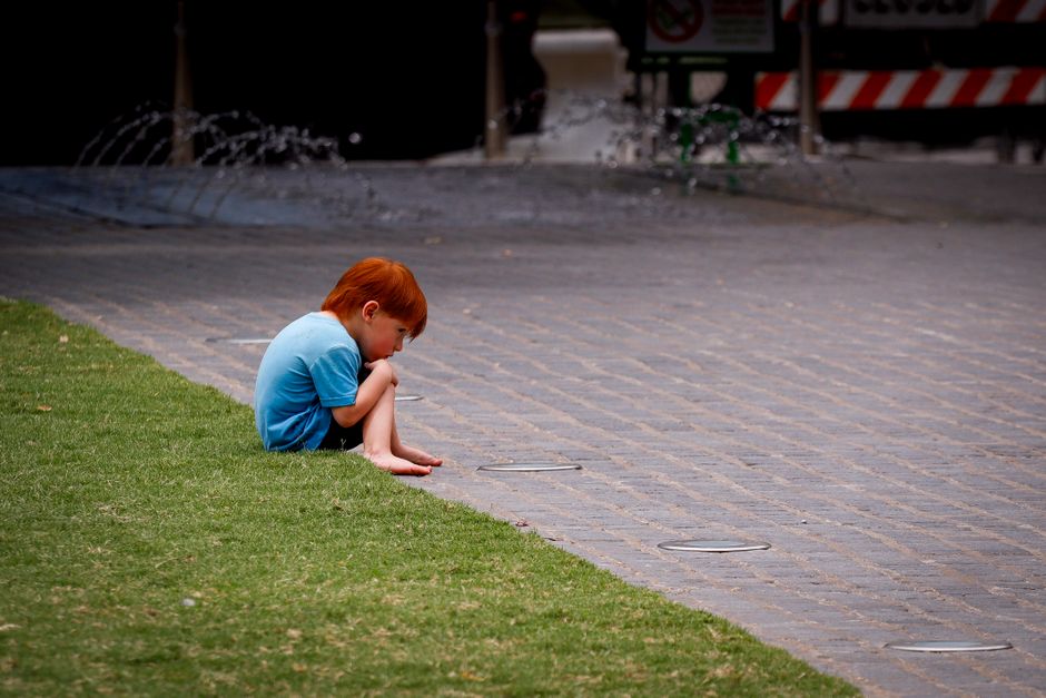 Criança pensativa brincando sozinha, representando TOC em crianças